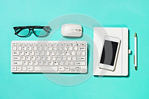 Office workplace with keyboard, notepad, succulent and pen