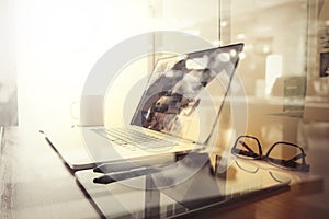 Office workplace with laptop and smart phone on wood table