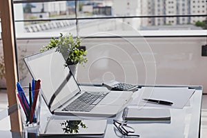 Office workplace, workspace with laptop computer on glass table, interior