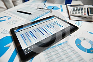 Office workspace for business. Tablet pc and reports. Table closeup. Business financial accounting concept