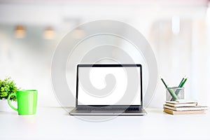 Office workspace mockup laptop computer, mug of coffee, jar of p