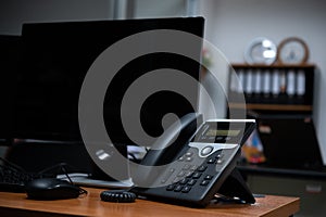 Office workspace with telephone and computer on table