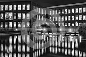 Officebuilding in Zoetermeer, Netherlands by night with reflection in the water in black and white