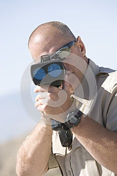 Officer Looking Through Radar Gun