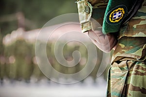 Officer`s hand holding beret during oath in Greek army