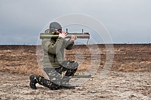 Officer special operations forces Ukraine army shoots from a grenade launcher