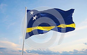 official flag of Curacao at cloudy sky background on sunset, panoramic view. patriot and travel concept. copy space for wide