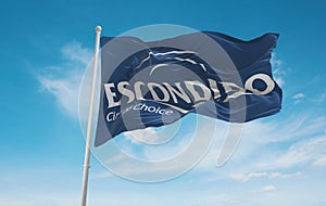 official flag of Escondido, California untied states of America at cloudy sky background on sunset, panoramic view. USA travel and photo