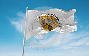 official flag of La Mirada, California untied states of America at cloudy sky background on sunset, panoramic view. USA travel and photo