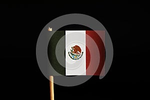 A official flag of Mexico on toothpick and on black background. Mexico belongs between the most criminality land in the world. Dru