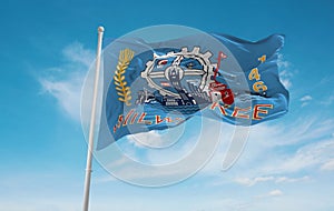 official flag of Milwaukee, Wisconsin untied states of America at cloudy sky background on sunset, panoramic view. USA travel and
