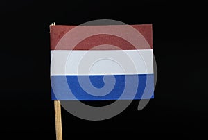 A official flag of the Netherlands on toothpick on black background. A horizontal triband of red, white, and cobalt blue. vlag van