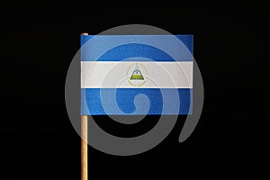 A official flag of nicaragua on toothpick on black background. The state is in central america in carribean sea.