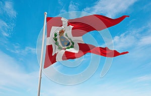 official flag of Nordfriesische, Denmark at cloudy sky background on sunset, panoramic view. Danish travel and patriot concept.