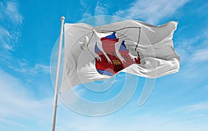 official flag of Randers, Denmark at cloudy sky background on sunset, panoramic view. Danish travel and patriot concept. copy