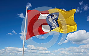 official flag of Sankt Poelten Austria at cloudy sky background on sunset, panoramic view. Austrian travel and patriot concept. photo