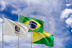 Official flags of the country Brazil, state of Acre and city of Rio Branco. Swaying in the wind under the blue sky. 3d rendering