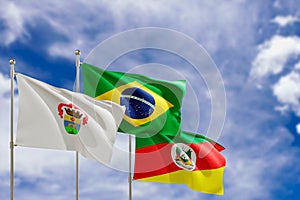 Official flags of the country Brazil, state of Rio Grande do Sul and city of Porto Alegre. Swaying in the wind under the blue sky