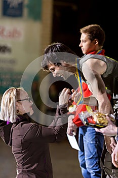 Official Lady granting Golden Medal to Winner