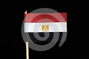 A official and national flag of Egypt on toothpick on black background. Flag consists red, white and black field with the egyptian