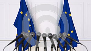 Official press conference. Flags of the European Union EU and microphones. Conceptual 3D rendering