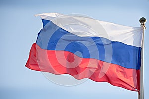 Official russian flag on the blue sky background