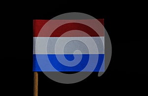 A official and very simple flag of Luxembourg on toothpick on black background. Flagge Luxemburgs. A horizontal triband of red,