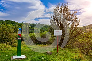 Official warning pole about the border zone of the Republic of Moldova with the state emblem on the plate. Background