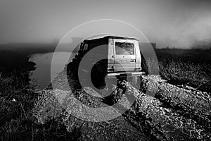 Offroad car on bad road. Water splash in off-road racing. Wheel close up in a countryside landscape with a muddy road.