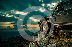 Offroad car on mountain road. Shock absorber for off road car. Car brakes with absorbers. Car tire. Tire for offroad.