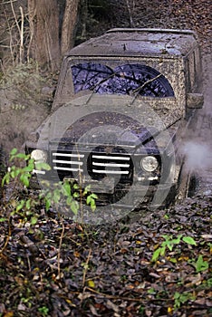 Offroad. Car moving through a large puddle of mud