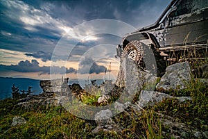 Offroad car. Off road suv moving on rocky stone mountains. Outdoor landscape. Adventure travel. Off road trail and