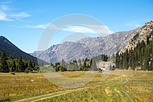 Offroad car is riding on gravel road. Overlanding concept. Kora river gorge in Kazakhstan, way to Burkhan bulak waterfall.