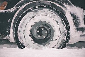 offroad car tires stuck in the snow - vintage film look
