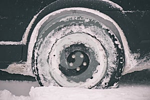 offroad car tires stuck in the snow - vintage film look
