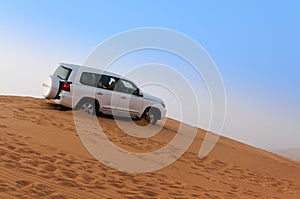 Offroad Desert Safari - Dune bashing with 4x4 vehicle in the Arabian sand dunes, Dubai, UAE