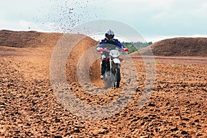 Offroad motorbike driving in dirt.