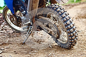 Offroad mountain motorcycle or bike taking part in motocros competition parked on dirty terrain road photo