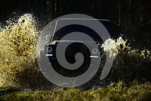 Offroad race on fall nature background. Extreme, challenge and 4x4 vehicle concept. SUV or offroad car on path covered