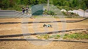 Offroad RC buggy driving on an outdoor dirt track