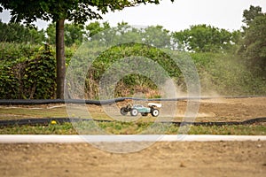 Offroad RC buggy driving on an outdoor dirt track