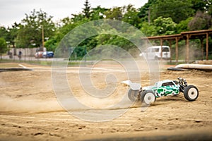 Offroad RC buggy driving on an outdoor dirt track