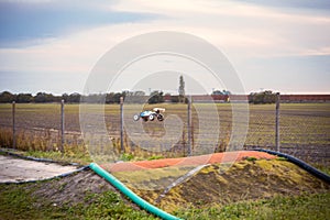 Offroad RC buggy driving on an outdoor dirt track