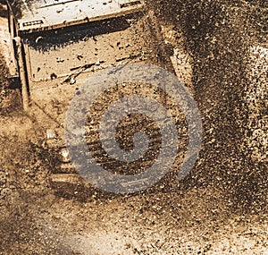 Offroad vehicle coming out of a mud hole hazard. Safari suv. Off-road travel on mountain road. Tracks on a muddy field