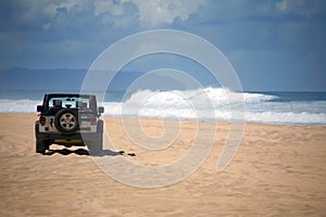 Offroad Vehicle on a Remote Beach in Hawaii photo