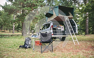 Offroad 4x4 vehicle with tent in roof ready for camping