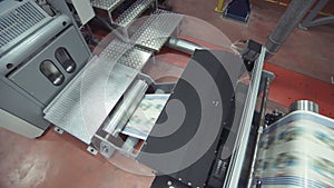 Offset printing press during production of printed paper products