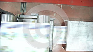 Offset printing press during production of printed paper products