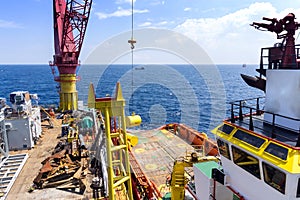 An offshore construction crane lifting anchor buoy for deployment