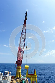 An offshore construction crane lifting anchor buoy for deployment